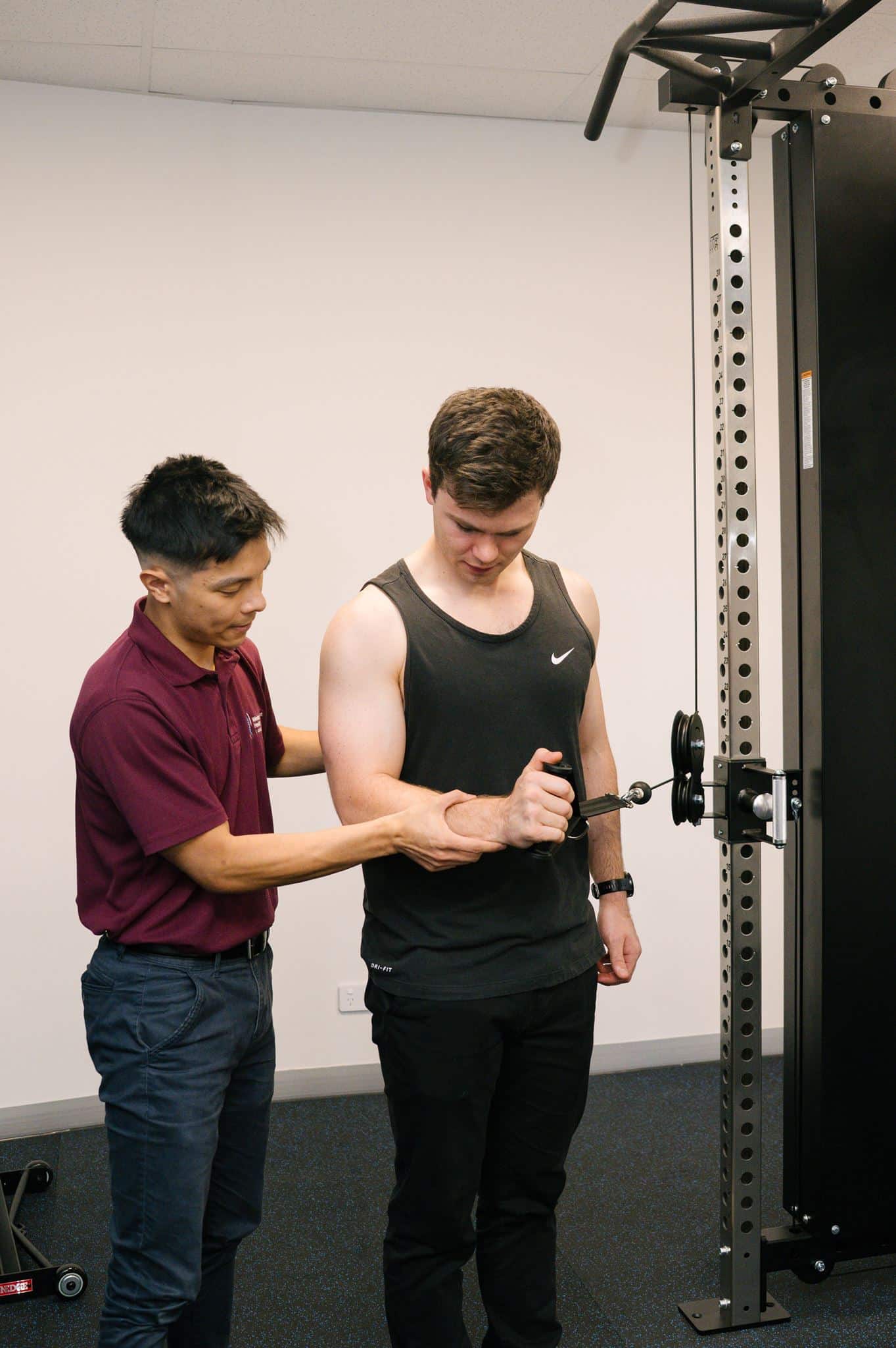 Coach helping participants with exercise technique